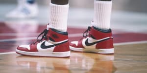 Michael Jordan dons a pair of Air Jordan 1s during a 1985 NBA match against the Bullets in Washington.