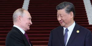 Russian President Vladimir Putin,left,and Chinese President Xi Jinping shake hands in Beijing. 