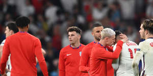England’s Phil Foden consoles teammate Jadon Sancho after he misses the side’s fourth penalty