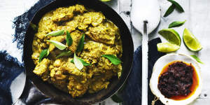 Lime wedges,fresh curry leaves and chilli sauce add colour to this chicken curry image.