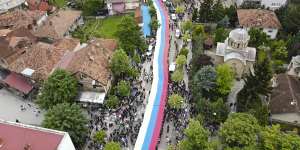 People hold a giant Serbian flag during a protest in the town of Zvecan,northern Kosovo,on May 31,against new Albanian mayors.