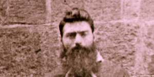 Portrait of Ned Kelly taken in Melbourne Gaol by Charles Nettleton,showing him hiding his withered left hand and arm by holding the cord attached to the leg iron.