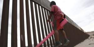 Seesaws straddle the Mexico border,and smiles shine through