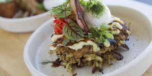 Okonomiyaki (savoury pancake) with bacon and poached egg.