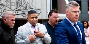 Sidelined Manly Sea Eagles hooker Manase Fainu leaves Parramatta District Court,flanked by security guards and his lawyer,after the guilty verdict.