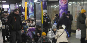 People gather in a subway station being used as a bomb shelter during a rocket attack in Kyiv on Thursday.