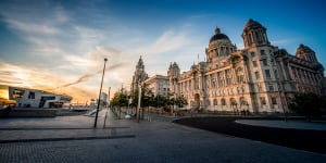 The historic Port of Liverpool building completes the so-called"Three Graces"on the waterfront,joining the Royal Liver Building and Cunard.