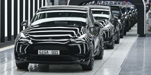 Model Y electric vehicles stand on a conveyor belt at the opening of the Tesla factory in Berlin Brandenburg in Gruenheide,Germany,in March. 