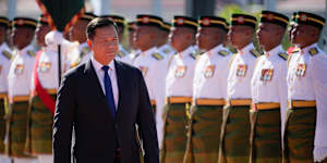 Cambodian Prime Minister Hun Manet inspects an honour guard during a visit to Malaysia. The prime minister’s family retains control of many senior roles in the Cambodian government.