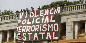 A banner is unfurled in Lisbon,Portugal. It translates to'Police violence,state terrorism'. 