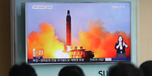 Anxious South Koreans watch footage of a North Korean ballistic missile launch last year