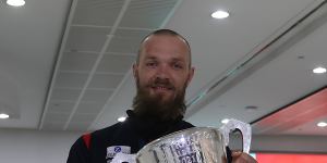 Max Gawn holds the premiership cup.