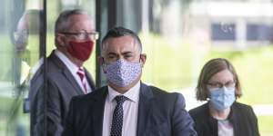 Acting Premier John Barilaro is flanked by Health Minister Brad Hazzard and Chief Health Officer Dr Kerry Chant on Tuesday. 