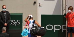A dejected Ash Barty leaves the court after retiring hurt during her second-round match.