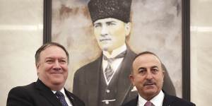 Turkey's Foreign Minister Mevlut Cavusoglu,right,and US Secretary of State Mike Pompeo shake hands before a meeting at the Esenboga Airport in Ankara,Turkey.