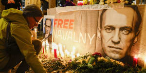 Pavel Shumilkin lights candles for a vigil held for Alexei Navalny outside City Hall in San Francisco on Friday night.