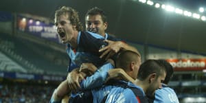 Sydney FC players celebrate after a Dwight Yorke goal in the first half of the Hyundai A-League opening game against Melbourne Victory at Aussie Stadium,Sydney,on August 28,2005.