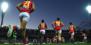 Lions players take to the field in Geelong.