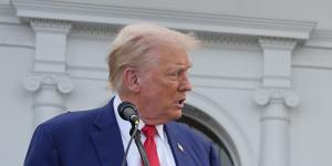 Donald Trump speaks at a news conference with groceries on display.