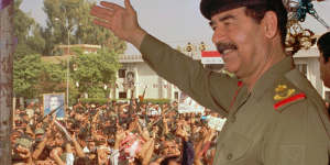 Then Iraqi president Saddam Hussein waves to supporters in Baghdad in 1995.