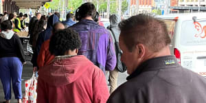 People queue for food outside Queen Victoria Market in Melbourne.