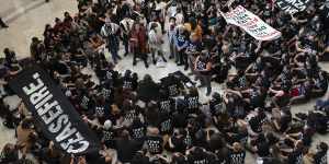 Demonstrators sit inside the Canon House office building calling on Congress for an immediate ceasefire and for humanitarian assistance to be allowed to enter Gaza,during a rally on Capitol Hill.