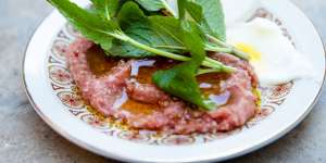 Kibbe nayeh,a pounded spread of raw beef,onion,burghul and dark,sweet spices. 