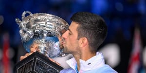 Novak Djokovic gets his hands on the Australian Open trophy for the 10th time.
