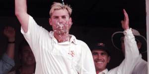 Shane Warne pours champagne over his head in after match celebrations.