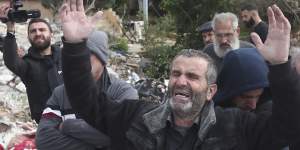 Ahmad Bazzi,pictured next to the remains of his house,which was destroyed by an Israeli airstrike in Bint Jbeil,southern Lebanon. Ahmad Bazzi is the father of Ali and Ibrahim Bazzi.