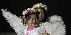 Girls dressed as angels smile during Easter Sunday rites in the Philippines in 2023.