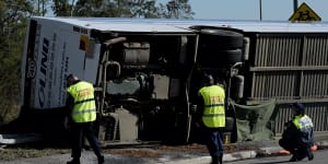 Police inspect the bus at the crash scene in the Hunter Valley last June.