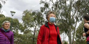 Margaret Alexander dons a mask on a crowded Princes Park trail.