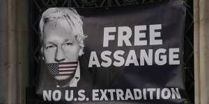 Supporters of Julian Assange fixed a large banner to a railing outside the High Court in London last year. 