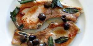 Pan fried pork chops with olives and sage.