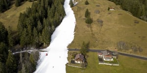 Skiers coast down artificial snow at 1600 metres above sea level in Villars-sur-Ollon,Switzerland,on New Year’s Eve.