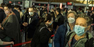 Qantas passengers queue at the security check-in at the Qantas domestic terminal in Sydney on Friday.