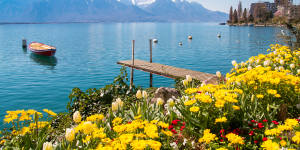 From a train en route to Montreux:flowers,mountains and jetty on Lake Geneva.
