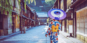 Woman in a kimono walking in the Higashi Chaya district of Kanazawa,Japan.