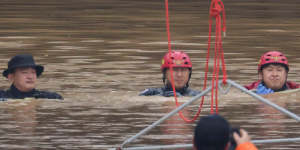 Rescue workers take part in a search and rescue operation near an underpass that has been submerged by a flooded river caused by torrential rain in Cheongju,South Korea on Sunday,July 16.