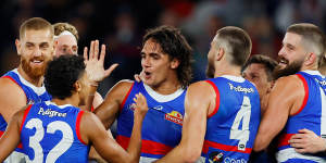 Jamarra Ugle-Hagan of the Bulldogs is swamped by teammates after one of his five goals.