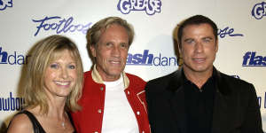 Randal Kleiser,centre,with Newton-John and John Travolta in more recent years.