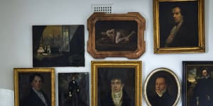 In the living room one wall displays 21 portraits of men dating from the 17th to early 20th centuries. Several pieces are designed by Longmuir,including the rug,standard lamp and table.