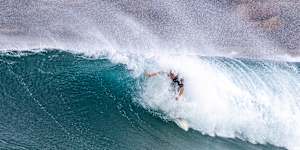 A surfer takes on the growing swell at Maroubra.