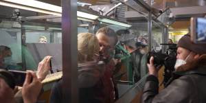 In this photo taken from video,Alexei Navalny kisses his wife Yulia as he is detained by police at the passport control after arriving at Sheremetyevo airport,outside Moscow,Russia.