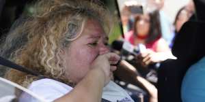 Grace Valencia,great aunt of shooting victim Uziyah Garcia,tries to hold back tears as she talks to the media from a vehicle after picking up a copy of the Texas House investigative committee report on the shootings.