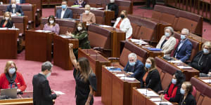 Greens senator Lidia Thorpe stands with her fist raised in the air as she is sworn in to the new Senate.