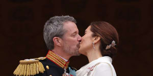 Danish King Frederik X and Queen Mary kiss on the balcony of Christiansborg Palace.