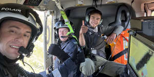 Nazari with rescue personnel in the helicopter that winched him to safety.