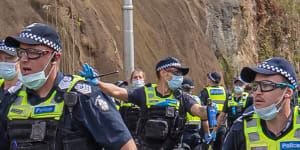 Age photographer Luis Ascui is pepper sprayed by a Victoria Police officer during the anti-lockdown protest in Richmond.